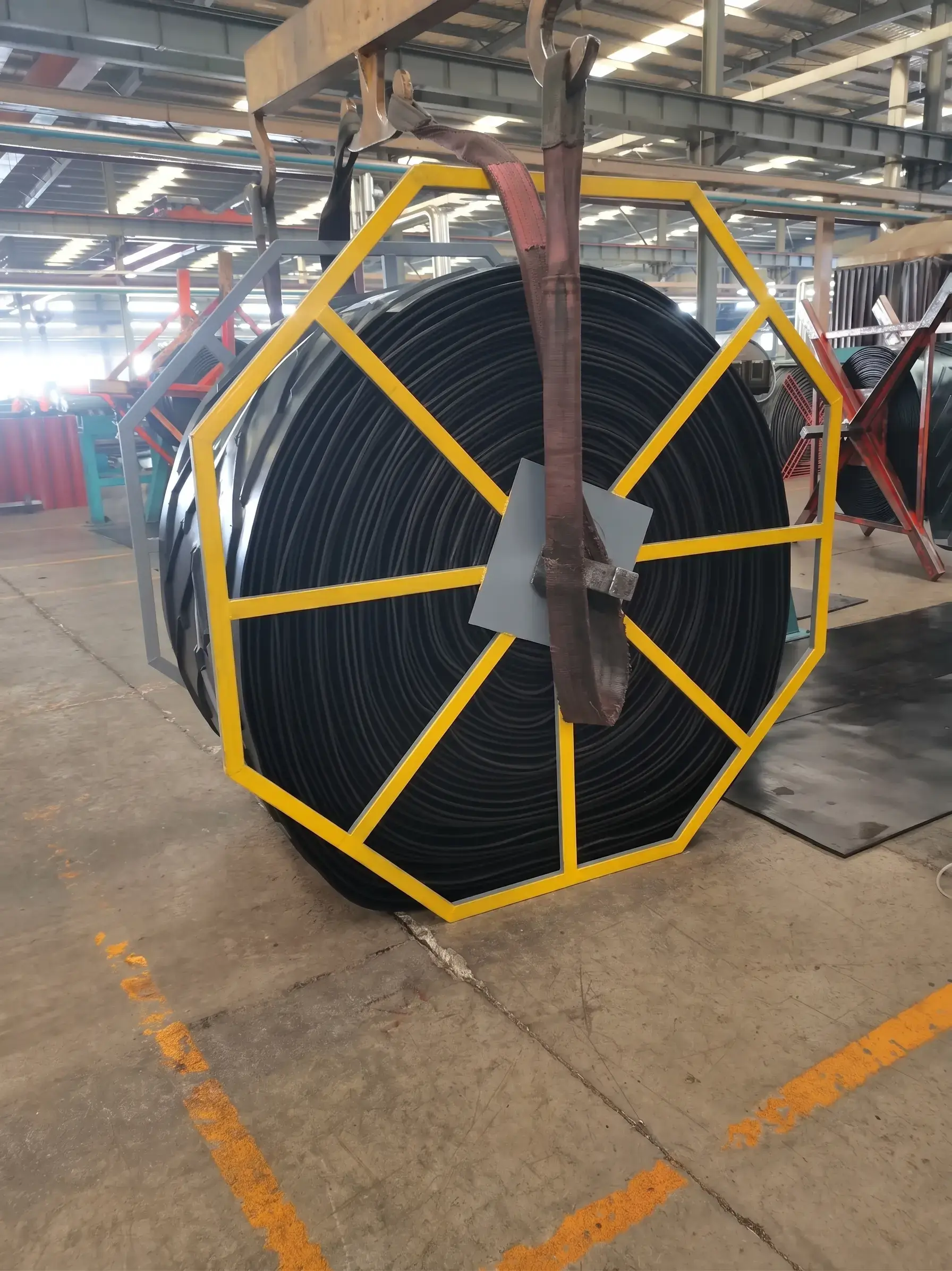 Steel cord rubber conveyor belt coil on reel in manufacturing factory for mining and bulk material handling